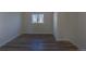 Cozy bedroom with wood-look floors and a window with natural light at 1435 Jay St, Lakewood, CO 80214