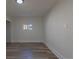 Bedroom featuring wood-look floors, white walls, and a window at 1435 Jay St, Lakewood, CO 80214