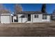 Front exterior showcasing the house's design with a tidy front yard and attached shed at 1435 Jay St, Lakewood, CO 80214