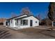 Charming one-story home featuring a stucco facade, black trim, and a well-maintained front yard at 1435 Jay St, Lakewood, CO 80214