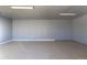 Spacious garage with concrete floors and fluorescent lighting at 1435 Jay St, Lakewood, CO 80214