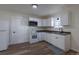 Cozy kitchen with white cabinets, modern appliances, and wood floors; refrigerator on left at 1435 Jay St, Lakewood, CO 80214