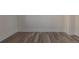 Neutral living area featuring wood plank flooring and white trim at 1435 Jay St, Lakewood, CO 80214