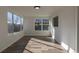 Sunlit living room featuring wood floors and multiple windows at 1435 Jay St, Lakewood, CO 80214
