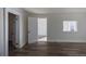Sunlit living room with vinyl wood flooring and two entry doors at 1435 Jay St, Lakewood, CO 80214