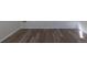 New vinyl plank flooring with base trim in well lit room at 1435 Jay St, Lakewood, CO 80214