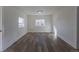 Spacious living room with wood floors, two windows providing natural light, and neutral-colored walls at 1435 Jay St, Lakewood, CO 80214