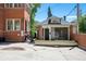 Backyard with a vintage stand-alone structure featuring lattice windows and access to brick building at 685 N Emerson St, Denver, CO 80218
