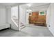 Basement with staircase, storage and a brick wall featuring exposed pipes and industrial lighting fixtures at 685 N Emerson St, Denver, CO 80218