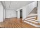 Spacious basement featuring a staircase, hardwood floors and white walls, perfect for storage or renovation at 685 N Emerson St, Denver, CO 80218