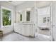 Elegant bathroom with double vanity, marble countertops, and a bright view to the exterior at 685 N Emerson St, Denver, CO 80218