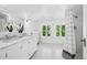 Bright bathroom with double vanity, marble countertop, and tiled shower at 685 N Emerson St, Denver, CO 80218