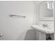 Simple bathroom featuring a pedestal sink, mirror, chrome towel bar and neutral wall paint at 685 N Emerson St, Denver, CO 80218