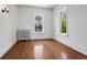 Bright bedroom with hardwood floors, radiator, and two windows offering natural light at 685 N Emerson St, Denver, CO 80218