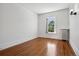 Minimalist bedroom with hardwood floors, vintage radiator, and a window for natural light at 685 N Emerson St, Denver, CO 80218