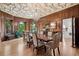 Elegant dining room with wood paneling, decorative ceiling, a chandelier, and large windows for natural light at 685 N Emerson St, Denver, CO 80218