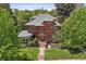 Beautiful red brick home surrounded by mature trees and lush landscaping at 685 N Emerson St, Denver, CO 80218