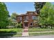 Stately brick home with lush green lawn and mature trees, offering classic elegance and curb appeal at 685 N Emerson St, Denver, CO 80218