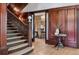 Grand foyer featuring a detailed staircase, wood paneling, and a glimpse into the dining room with a chandelier at 685 N Emerson St, Denver, CO 80218