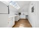 Cozy, white kitchen with modern appliances, hardwood floors and a large skylight providing natural light at 685 N Emerson St, Denver, CO 80218