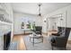 Cozy living room featuring hardwood floors, gray chairs, decorative fireplace, and abundant natural light at 685 N Emerson St, Denver, CO 80218