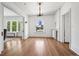 Sunlit living room has wood floors, large windows, and traditional trim at 685 N Emerson St, Denver, CO 80218
