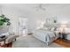 Bright main bedroom features a plush bed, neutral decor, ceiling fan, and an en suite bathroom at 685 N Emerson St, Denver, CO 80218
