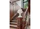 Detailed staircase with wood paneling, marble steps, and an ornate banister with a decorative white vase on the post at 685 N Emerson St, Denver, CO 80218