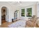 Cozy sun room with wicker chairs, large windows, and a decorative rug on hardwood floors at 685 N Emerson St, Denver, CO 80218