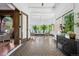 Open sunroom with patterned tile, natural light from large windows, and a view into adjacent living spaces at 685 N Emerson St, Denver, CO 80218