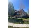 Charming two-story home with landscaped front yard and mature trees offering shade and curb appeal at 2170 Granite Dr, Brighton, CO 80603
