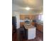 Well-lit kitchen featuring wooden cabinets, stainless steel appliances, and an island with seating at 2170 Granite Dr, Brighton, CO 80603