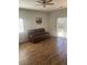 Bright living room with hardwood floors, a sliding glass door, and a comfortable brown sofa at 2170 Granite Dr, Brighton, CO 80603