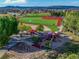 Aerial view of community park featuring baseball field, playground, and picnic area at 4061 Nordland Trl, Castle Rock, CO 80109