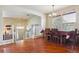 Charming dining area featuring hardwood floors, a chandelier, and views of the staircase and front entry at 4061 Nordland Trl, Castle Rock, CO 80109