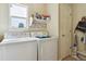Functional laundry room with a washer, dryer, and storage shelves, providing convenience and organization at 4061 Nordland Trl, Castle Rock, CO 80109