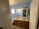 Bright bathroom featuring a double sink vanity with a large mirror and ample lighting at 21300 E 42Nd Ave, Denver, CO 80249