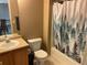 Bathroom featuring a toilet, vanity with sink, and a shower with a nature-themed curtain at 21300 E 42Nd Ave, Denver, CO 80249