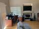 Comfortable living area with hardwood floors, a built-in entertainment center, and natural light at 21300 E 42Nd Ave, Denver, CO 80249