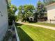 Landscaped side yard featuring a winding walkway and verdant green grass at 21300 E 42Nd Ave, Denver, CO 80249