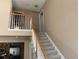 Open staircase with carpeted steps and white railings leading to the upper level at 21300 E 42Nd Ave, Denver, CO 80249