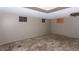 Unfinished basement featuring a drop ceiling and minimal natural light through small windows at 415 Winona Ct, Denver, CO 80204