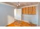 Bedroom with hardwood floors, window boarded up and closet at 415 Winona Ct, Denver, CO 80204