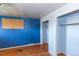 Bedroom with hardwood floors and blue walls with closet at 415 Winona Ct, Denver, CO 80204