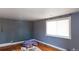 Bedroom with hardwood floors and light blue walls needing some repairs at 415 Winona Ct, Denver, CO 80204