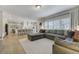 Open concept living room featuring hardwood floors, plantation shutters, and access to the kitchen at 3940 Wynwood Cir, Highlands Ranch, CO 80126