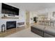 Bright living room with a cozy fireplace and an open floor plan that leads into the kitchen at 3940 Wynwood Cir, Highlands Ranch, CO 80126