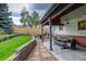 A spacious backyard featuring outdoor seating, a beautiful lawn, and a well-maintained fence at 66 Yank Way, Lakewood, CO 80228