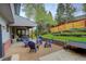 Backyard oasis with patio, fire pit, seating area, and lush lawn at 66 Yank Way, Lakewood, CO 80228