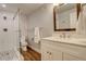 Modern bathroom with glass shower, stylish vanity, and wood-look flooring at 66 Yank Way, Lakewood, CO 80228